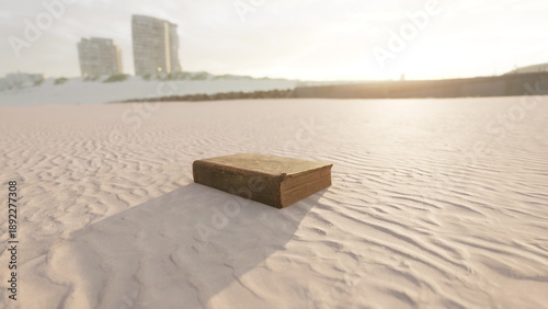 Canvas Print Under the golden glow of sunset, an ancient book lies on a tranquil sandy beach, waves lapping gently nearby, evoking a sense of mystery and stories untold