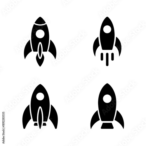 four black rocket ship icons on white background