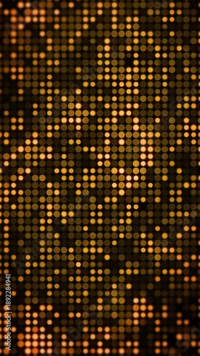 Shimmering grid of amber and gold lights, resembling an electronic LED screen or disco floor. Bokeh effect in a warm, festive atmosphere. Loop animation. Vertical video.