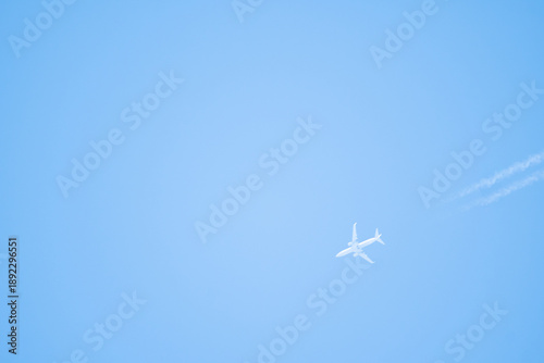 unmarked commercial jetliner leaving contrails behind in its atmospheric flight with a cruising altitude of 35k feet above the sealevel along the Atlantic seaboard