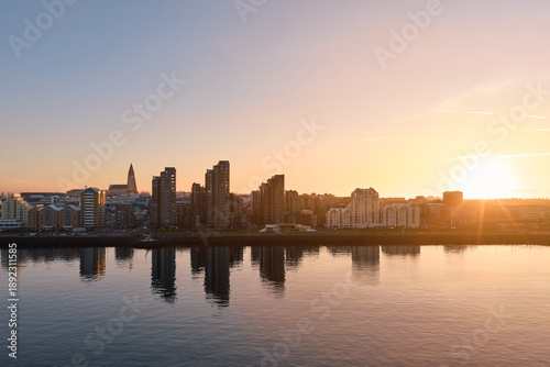 Reykjavik cityscape reflecting golden light over water