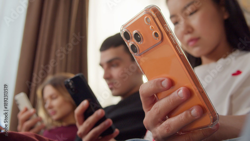 Konstfotografi Sad ignore friends sit couch at home living room using smartphone