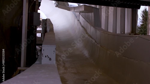 Luge athlete racing down the ice track