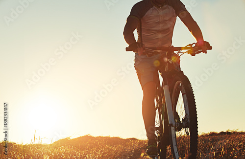Wallpaper Mural Fitness, sunset or legs outdoor with cycling, endurance training or challenge in cardio workout. Flare, space or man in nature with bike, physical activity or sports hobby in summer evening. Torontodigital.ca