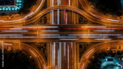 Aerial Night Highway Interchange with Light Trails, Motion Blur, Urban Traffic Flow