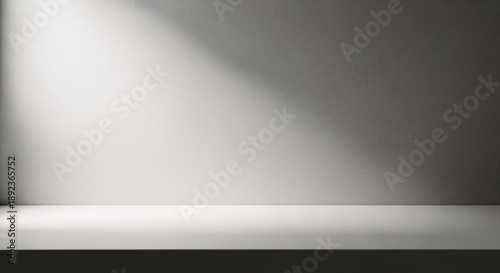 Wallpaper Mural Minimalist concrete wall with bright diagonal spotlight illuminating a clean white shelf against a dark textured floor creating a dramatic atmospheric backdrop perfect for product display Torontodigital.ca