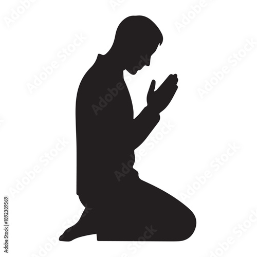 A kneeling man in prayer a striking black silhouette