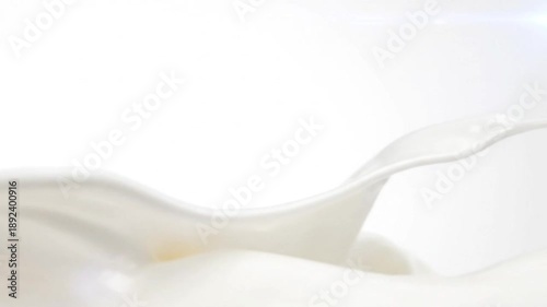 close up shot of fresh white milk splash against a clean white background with copy space
