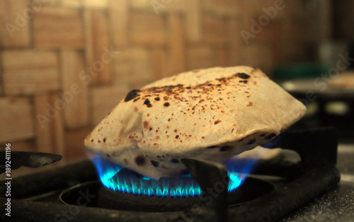 Indian Roti Puffing on Gas Stove, Traditional Home Cooking Scene