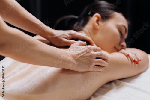 Wallpaper Mural Female client receiving a relaxing massage from a therapist at a wellness center, with soft lighting and a tranquil atmosphere enhancing the spa experience Torontodigital.ca