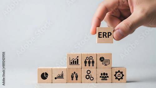 Hand placing erp block among various business icons