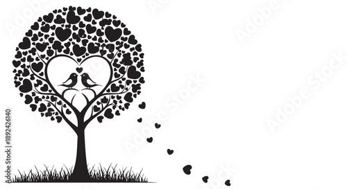 Silhouette of two love birds perched on a heart shaped tree branch