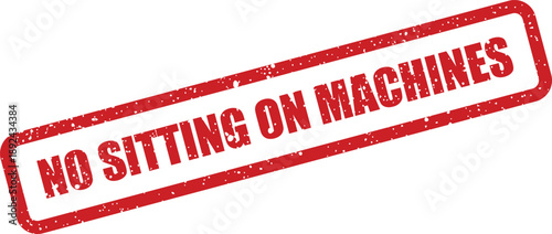 A bold red warning sign clearly states NO SITTING ON MACHINES in a distressed stamp style