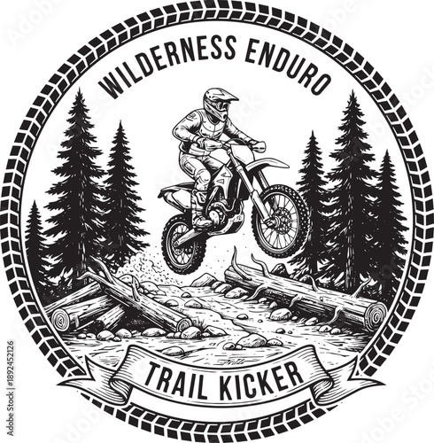 A dirt bike rider in mid-air jumping over logs on a forest trail surrounded by trees, viewed from the side.