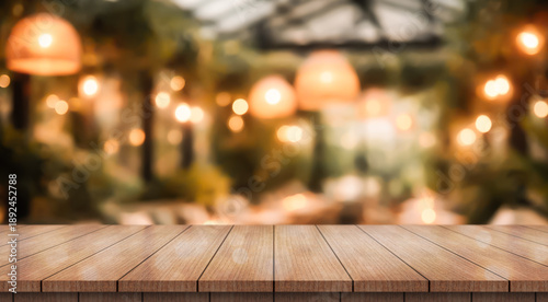 Empty wooden table top with lights bokeh on blur restaurant background