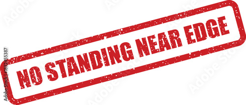 Prominent red grunge rubber stamp warns No Standing Near Edge with a distressed texture against a white backdrop