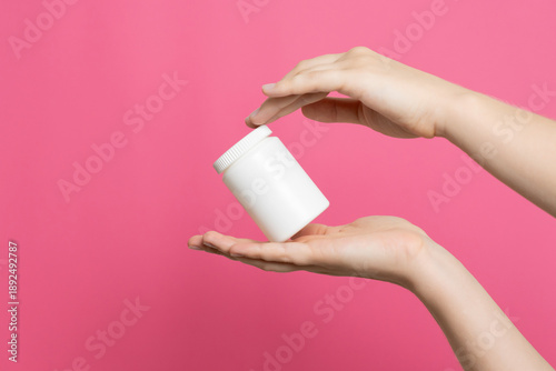 Hands holding white blank bottle for medicine product