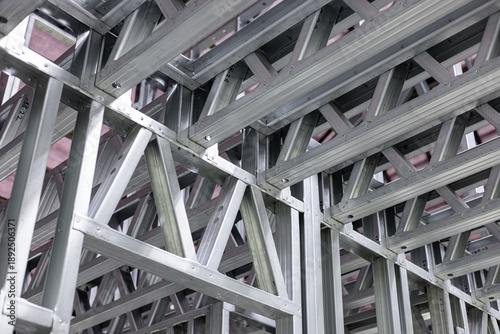 New home construction framing. Metal stud framing system with rust resistant coating in a drywall assembly. Structure of steel for building construction. Metal house frame.