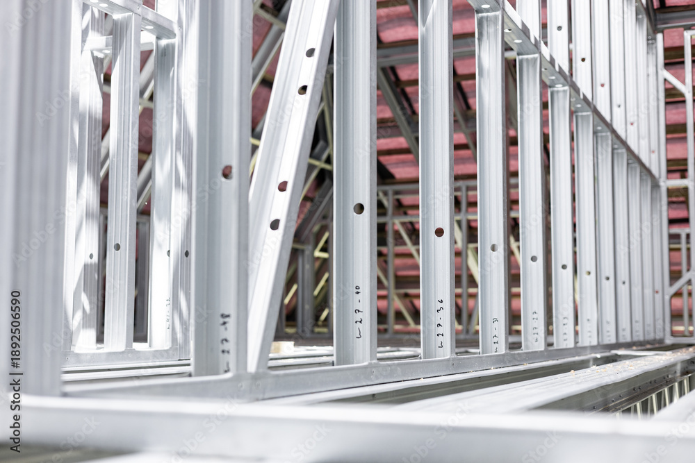 Obraz premium New home construction framing. Metal stud framing system with rust resistant coating in a drywall assembly. Structure of steel for building construction. Metal house frame.