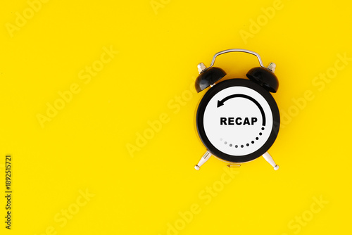Recap economy, business, financial concept. For business planning. RECAP word inside circle frame on clock, yellow background and copy space