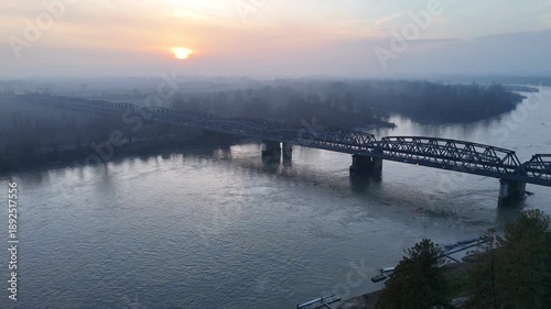 Wallpaper Mural Traffic crossing the Ponte di Ferro between Cremona and Castelvetro Piacentino over the Po River, showing steel bridge infrastructure and regional border Lombardy - Emilia Romagna, slow motion Torontodigital.ca