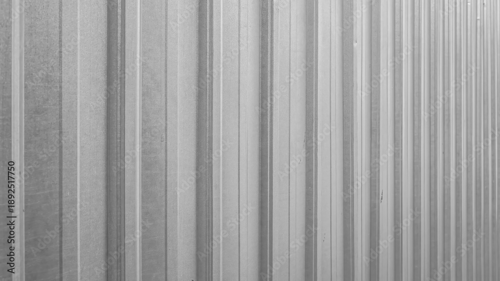 Obraz premium Corrugated metal sheet in gray, industrial striped background texture.
