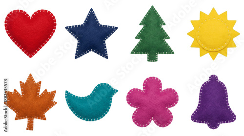 Colorful felt ornament set including heart, star, tree, sun, leaf, bird, flower, and bell shapes isolated. Handmade textile sewing decoration collection.