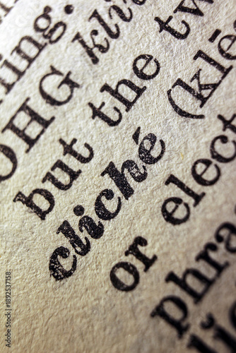 Fotografi Word cliche printed on dictionary page, macro close up