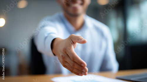 First person POV perspective of Asian businessman extending hand for greeting handshake partnership deal agreement from candidate viewpoint recruitment job offer moment with