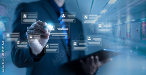 Foto Businessman managing digital user profiles and data cards on virtual interface,