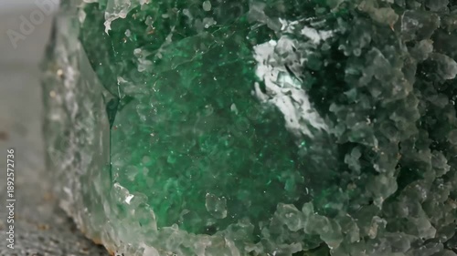 Closeup macro shot of vibrant green and clear crystal formations, showcasing natural beauty.