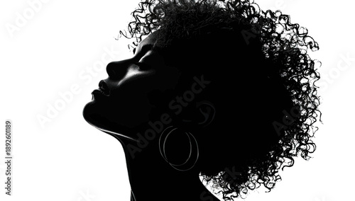 Dramatic black and white profile of a woman with curly hair looking skyward