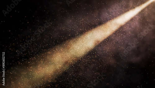 Projector beam with golden tint illuminating fine dust particles in a dark theater