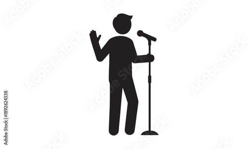 Silhouette of a person speaking into a microphone, public speaking or performance.