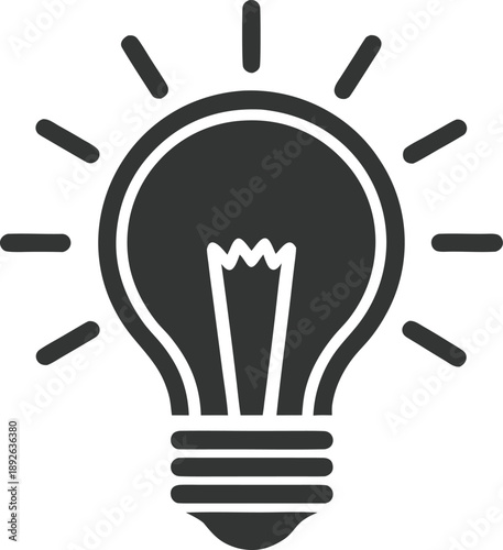 A black silhouette of a lightbulb with radiating lines of light