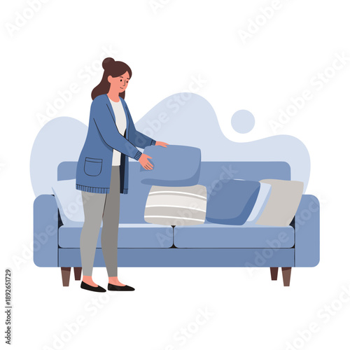 Young caucasian female arranging cushions on blue sofa in modern living room