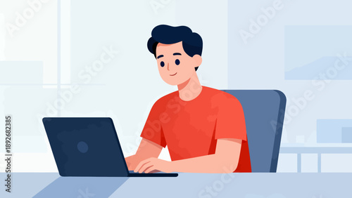 A man is sitting at a desk with a laptop in front of him. He is smiling and he is enjoying his work