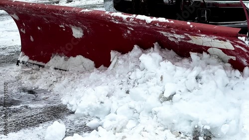 Heavy-duty snowplow clearing a road by pushing fresh snow and ice to the side