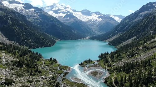Stunning aerial view of a glacial lake surrounded by mountains.