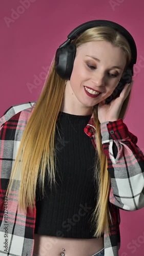 Portrait of dancing young woman with headphones, slow motion