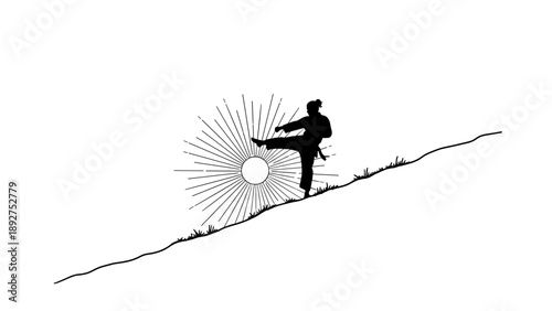 Silhouette of martial artist kicking on a hill with radiant sunburst background