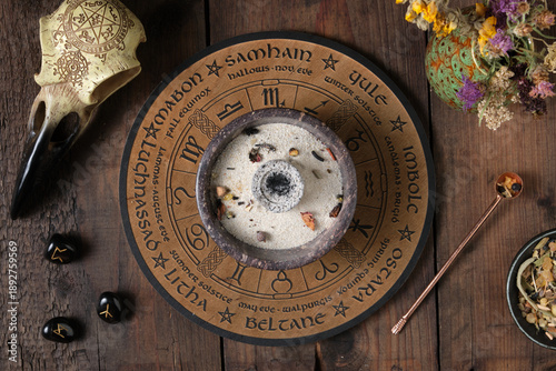 Preparation for a Wicca incense ritual with herbs, resins and mystical symbols
