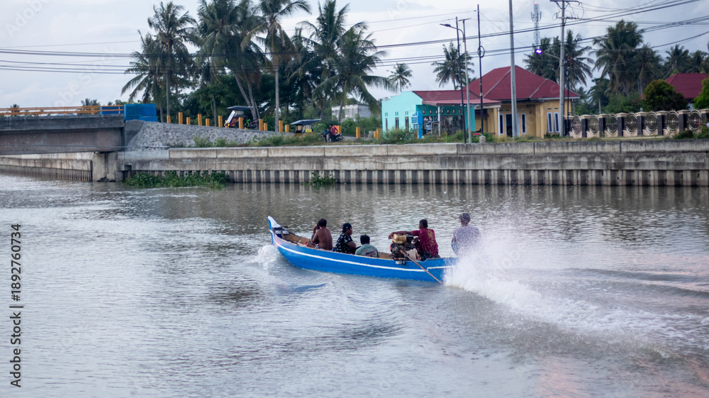 Fototapeta premium Motorboat Travels Through a Canal