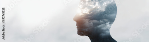 Digital literacy concept with human profile and cloudy sky overlay symbolizing knowledge and imagination in creative artistic style