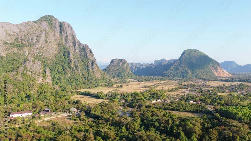 custom made wallpaper toronto digitalGolden sun setting behind dark mountain silhouettes. Orange sky during golden hour in a scenic southeastern asian landscape
