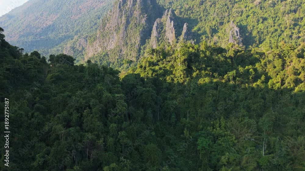 custom made wallpaper toronto digitalParaglider flies over Laos mountains at sunset with a warm orange sky and silhouette of hills shot from a unique aerial perspective