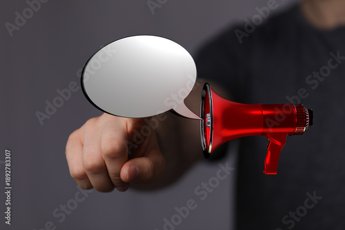 A hand pointing with a mega...