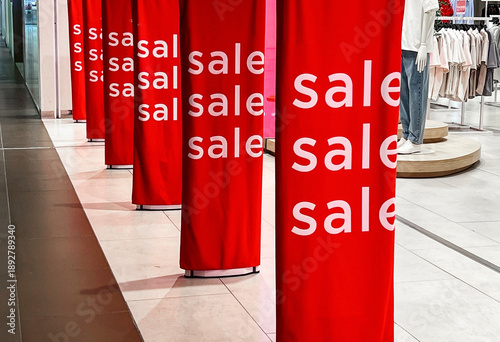 Photos Bright red sale banners attract shoppers in a busy mall