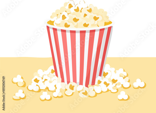 Red and white striped popcorn bucket overflowing with popcorn.