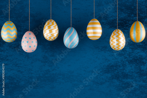 Colorful hanging easter eggs with striped and dotted patterns on blue background. 3d rendering